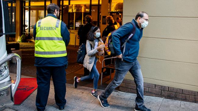 A man and child walking to a car after being quarantined for two weeks at Playford Hotel in Adelaide. Picture: The Advertiser/Morgan Sette