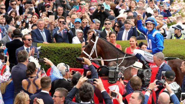 Hugh Bowman returns to scale on Winx to the cheers of the crowd. Picture: AAP 