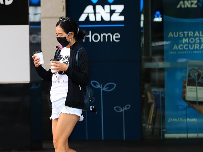 Morning commuter wearing a face mask for protection from Corona virus in the Brisbane CBD.  Photo Lachie Millard