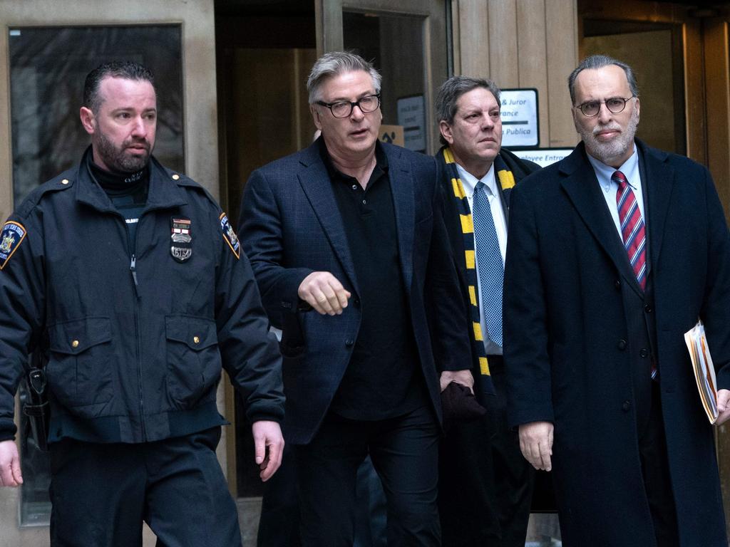 Alec Baldwin, centre, departing New York County Criminal Court on January 23, 2019 in New York after he pleaded guilty to a second-degree harassment violation stemming from when he punched a man during a dispute over a New York City parking spot. Picture: AFP