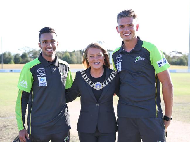 Hills Shire Mayor Yvonne Keane with Sydney Thunder players Chris Green and Arjun Nair.