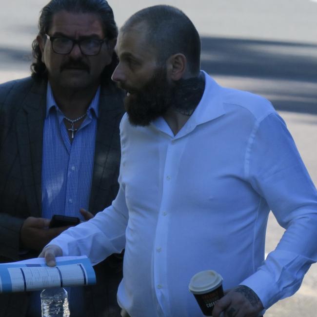 Moujalli (white shirt) arriving at Gosford District Court with a supporter. Picture: NewsLocal