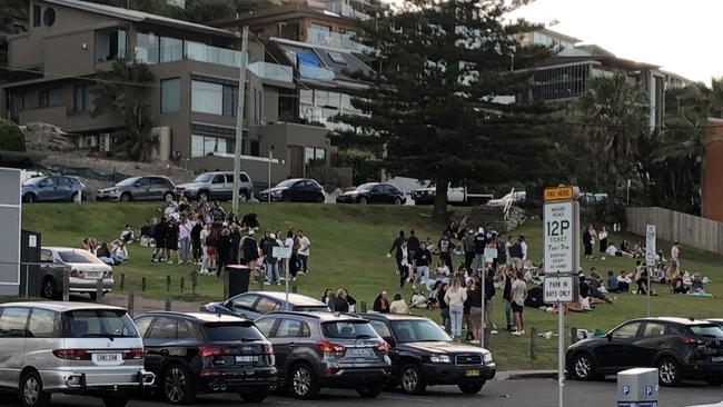 People gathering to socialise at about 6.45pm on Saturday at the reserve between Moore and Undercliff roads at Freshwater Beach. Picture: Jim O'Rourke