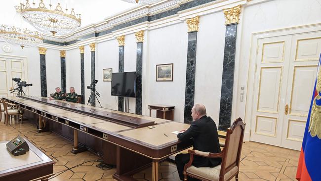 Russian President Vladimir Putin (R) meets with Defence Minister Sergei Shoigu (2L) and chief of the general staff Valery Gerasimov in Moscow on February 27. Picture: AFP