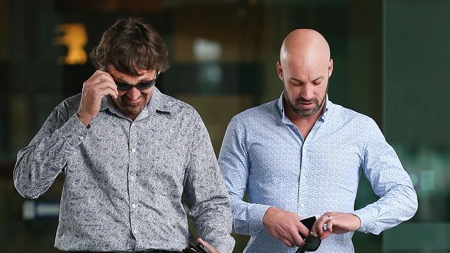 Plumber Lucas Nicoll, right, leaves the union royal commission hearings in Brisbane. Picture: Jack Tran.