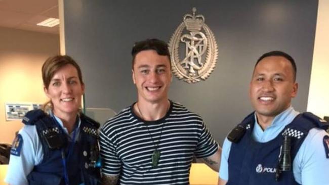 Charnze Nicoll-Klokstad poses with police after finding his debut jersey.