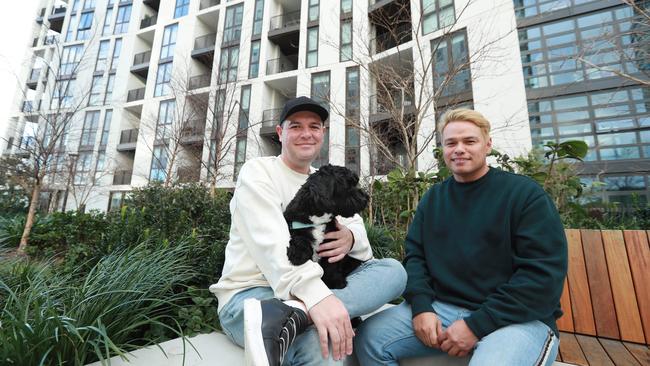 Tom Pospieszny with Joshie and partner RJ Wikaira, who live within Mirvac’s new Build-to-Rent development at Olympic Park. Picture: John Feder