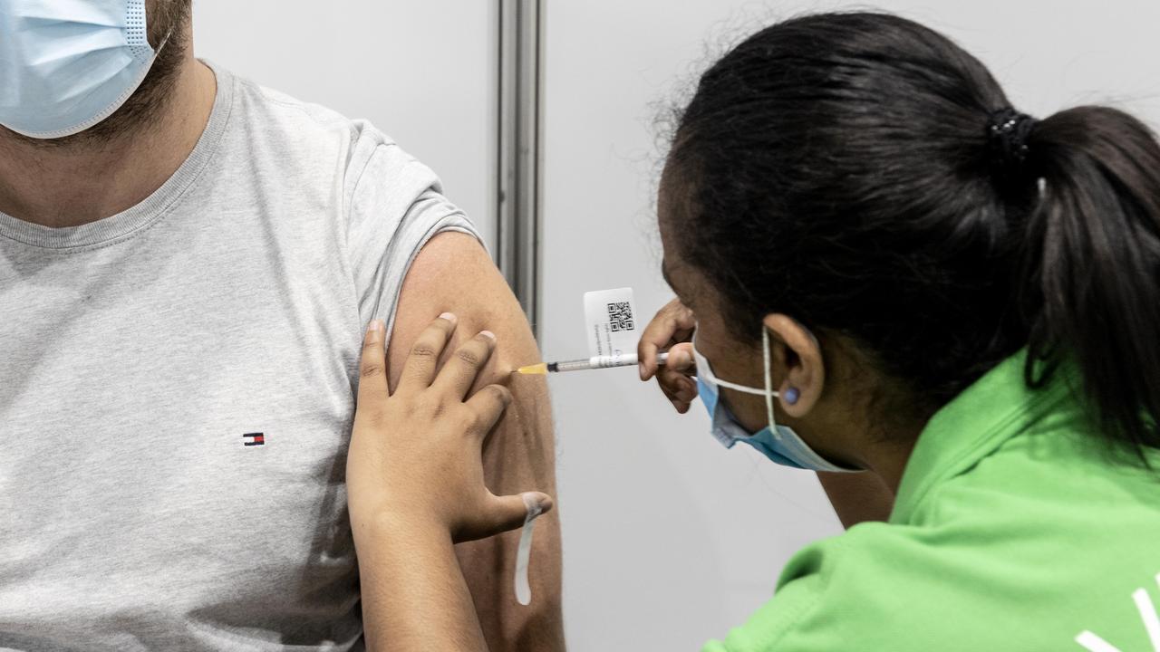 Rhys Barnes gets a Pfizer vaccination from enrolled nurse Maria Mathews at the Brisbane Convention and Exhibition centre vaccination hub. NewsWire: Sarah Marshall