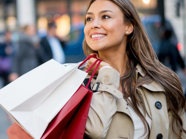 A woman carrying her shopping bags after spending money on her credit card. Picture: iStock.