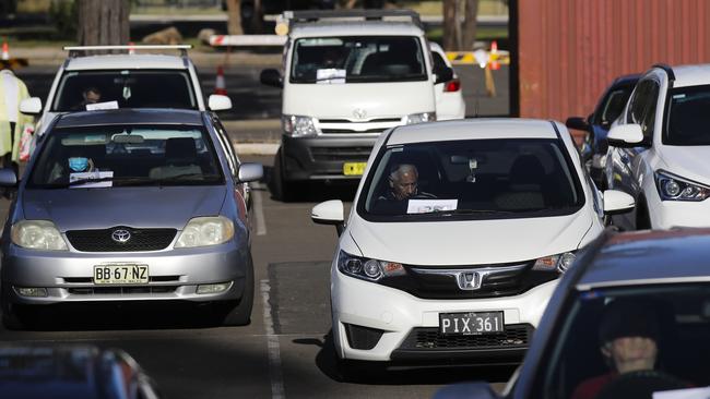 Cars are positioned in a parking lot at Fairfield Drive-Through Clinic COVID-19 testing today. Picture: Dylan Robinson