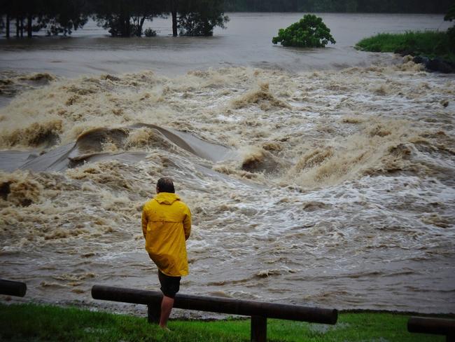 A causeway overflows in the Gold Coast suburb of Oxenford. Picture: Brett Faulkner