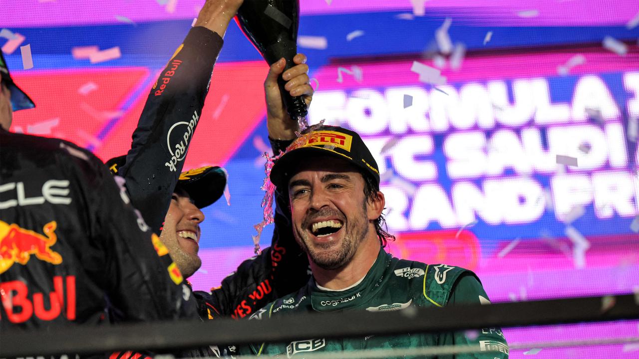 Alonso celebrating another podium. (Photo by Giuseppe CACACE / AFP)