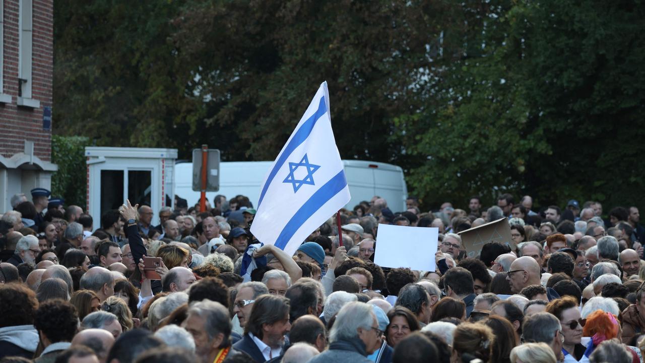 A protester waves an Israeli national flag during a rally in support of the people of Israel Picture: Simon Wohlfahrt / AFP