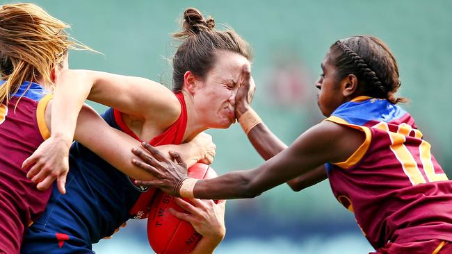 Daisy Pearce tackled by Emily Bates and Delma Gisu during the 2016 AFL match between the Melbourne Demons and the Brisbane Lions. Pic: Scott Barbour/AFL Media/Getty Images