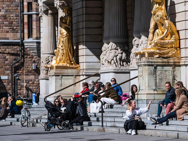 People enjoying the spring weather outside the Royal Dramatic Theatre in Stockholm during the coronavirus pandemic. More than 1200 people have died in the country. Picture: Jonathan Nackstrand/AFP