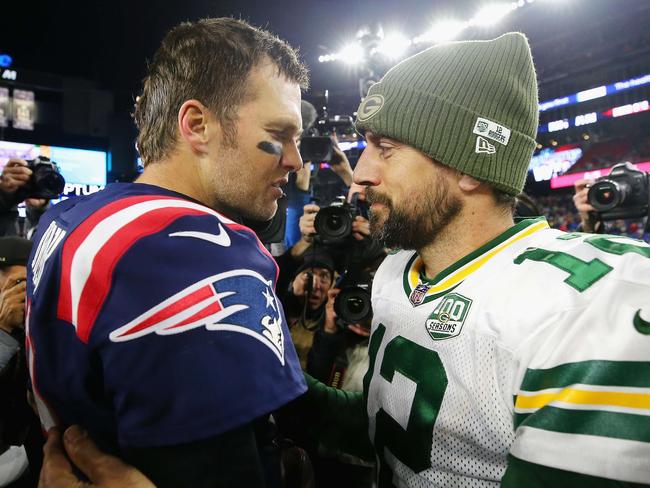 FOXBOROUGH, MA - NOVEMBER 04: Tom Brady #12 of the New England Patriots talks with Aaron Rodgers #12 of the Green Bay Packers after the Patriots defeated the Packers 31-17 at Gillette Stadium on November 4, 2018 in Foxborough, Massachusetts.   Maddie Meyer/Getty Images/AFP == FOR NEWSPAPERS, INTERNET, TELCOS & TELEVISION USE ONLY ==