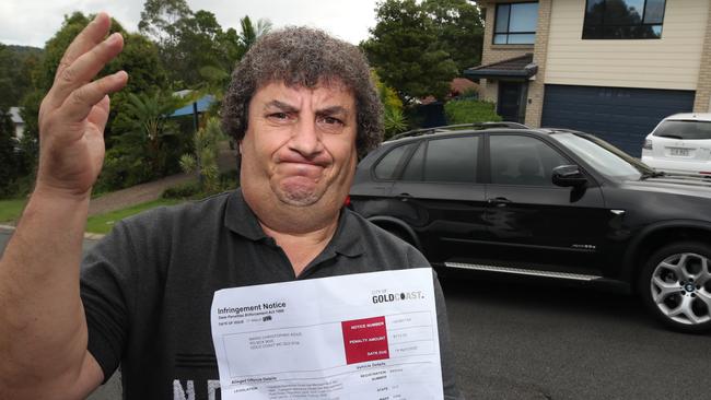 Pacific Pines resident Mario Agius with his parking ticket. Picture Glenn Hampson