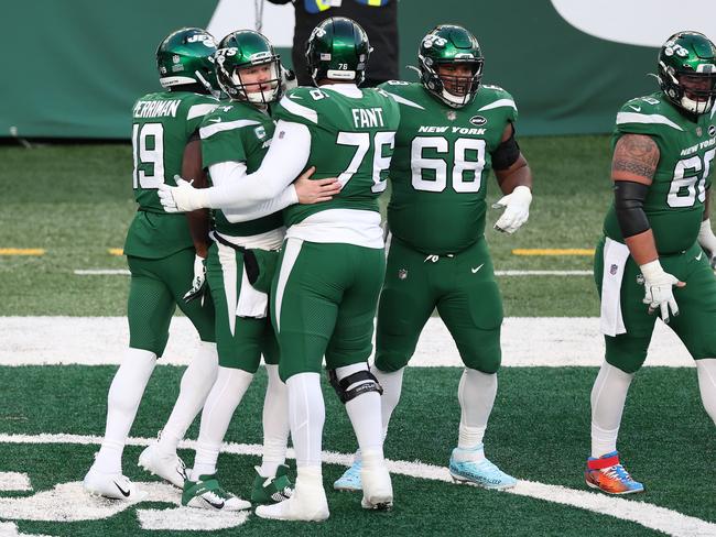 Teammates congratulate Sam Darnold after the Jets scored against the Raiders.