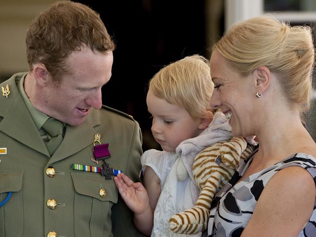 Trooper Mark Donaldson with his wife Emma and daughter Kaylee after receiving the Victoria Cross from the Governor-General.