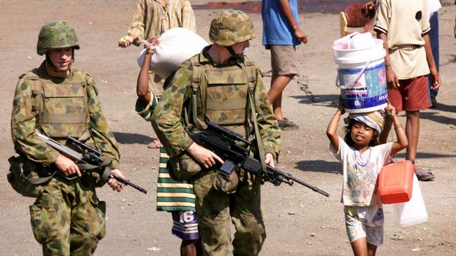 Australian soldiers with refugees from the port of Dili, East Timor, in 1999.