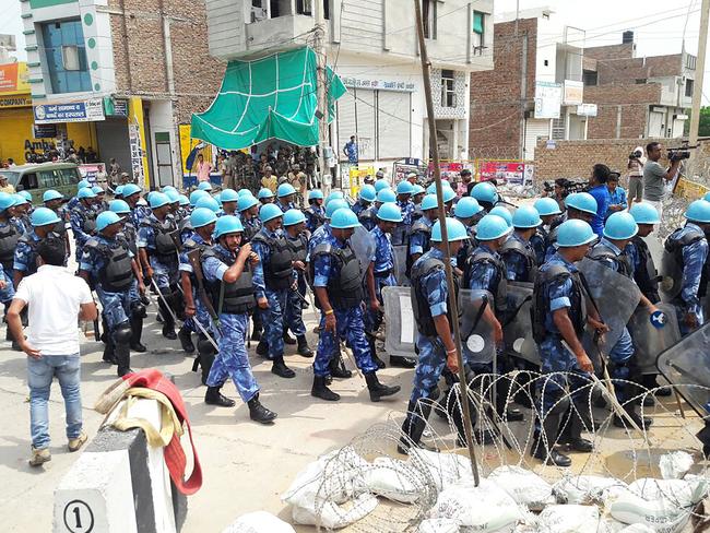 Indian paramilitary personnel walk towards the Dera Sacha Sauda Ashram in Sirsa after followers of controversial guru Ram Rahim Singh  went on a rampage. Picture: AFP