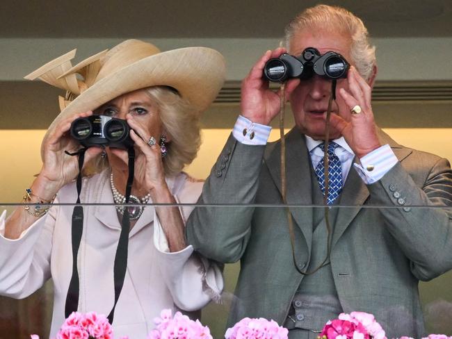 The King and Queen Camilla watch the races with their binoculars. Picture: AFP