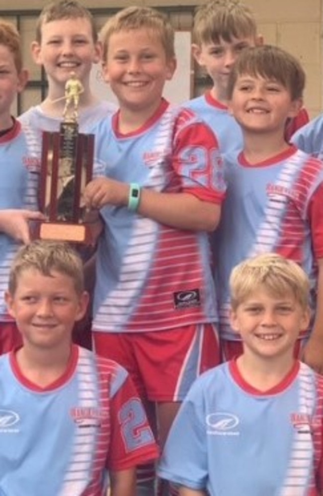 Wanderers' state reps (clockwise from left) Jace Harmsworth (holding trophy), Alfred Timms, Egan Cass and Eli Landsberg celebrate one of their Rockhampton junior premierships.