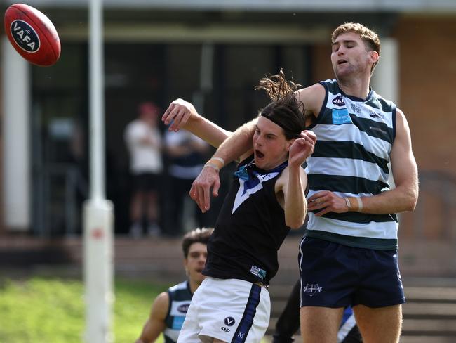 VAFA: Will McFarlane of Old Geelong catches Mazenod’s Fletcher Ford a tad high. Photo: Hamish Blair