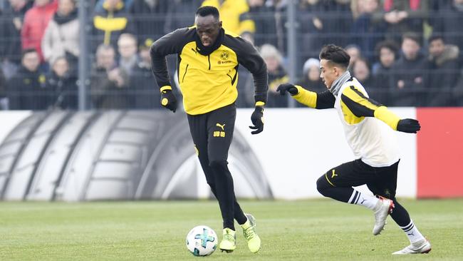 Retired Jamaican Olympic and World champion sprinter Usain Bolt (left) during a training session with German team Borussia Dortmund in March. Photo: AFP