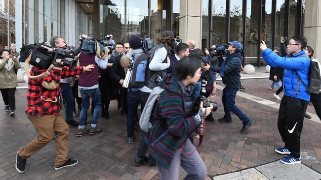 The moving media scrum around Xuan Dong outside NSW Supreme Court today.