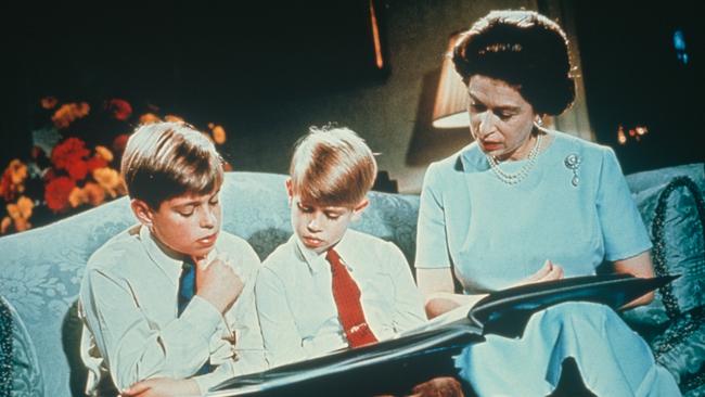 Queen Elizabeth II looking at a photograph album with her sons Prince Andrew (left) and Prince Edward, in 1971.