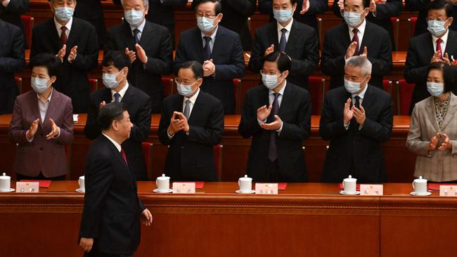 Xi Jinping is applauded as he arrives for the closing session of the National People's Congress.