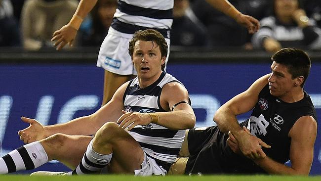 Patrick Dangerfield appeared to immediately appeal for a free kick, thinking he had caught Matthew Kreuzer holding the ball. Picture: AAP