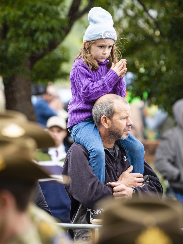 Dale McNaughton gives his niece Evelyn Hine an elevated view of the Anzac Day morning march, Monday, April 25, 2022. Picture: Kevin Farmer