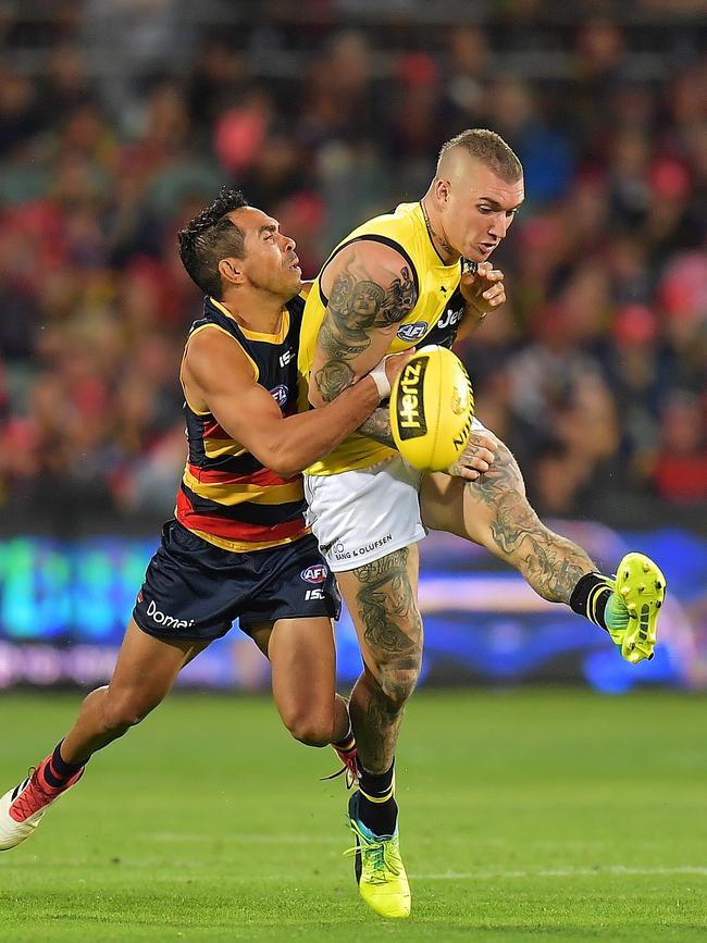 Crows star Eddie Betts tackles Brownlow Medallist Dustin Martin at Adelaide Oval on Thursday night. Picture: Daniel Kalisz/Getty Images