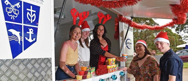 John Paul College students from left, Sara, Sarah and Brooke, Lauryn, Liam with their food van, which supports people in need in central Frankston. Picture: Andrew Batsch