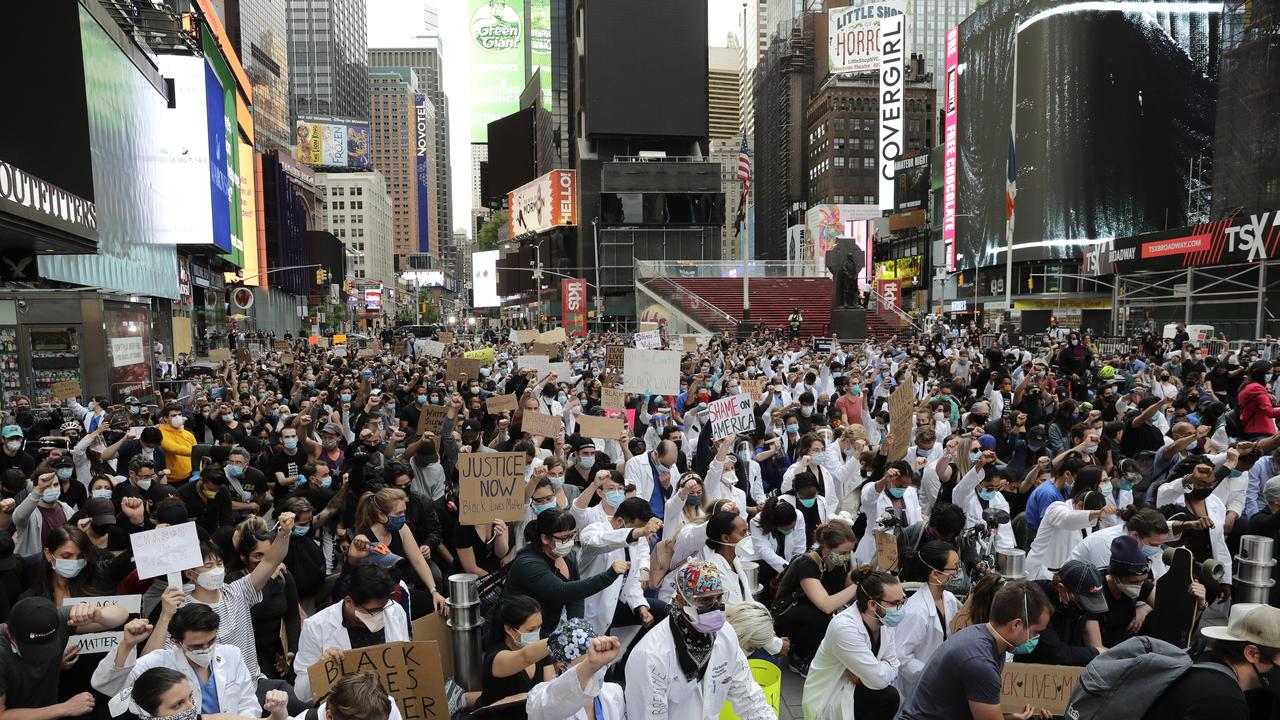 Protesters kneel in Times Square in New York. Picture: AP/Seth Wenig