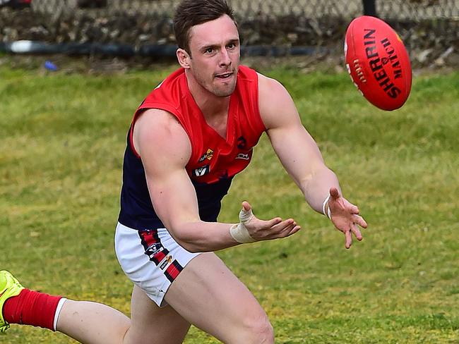 Pictured is Peninsula Football Netball League round 15 game of Australian Rules Football Langwarrin ( blue and white with blue shorts ) versus Mt Eliza ( red, white, blue with white shorts ) at Lloyd Park in Langwarrin. Justin Van Unen leads but the ball is out of bounds. Picture: Derrick den Hollander