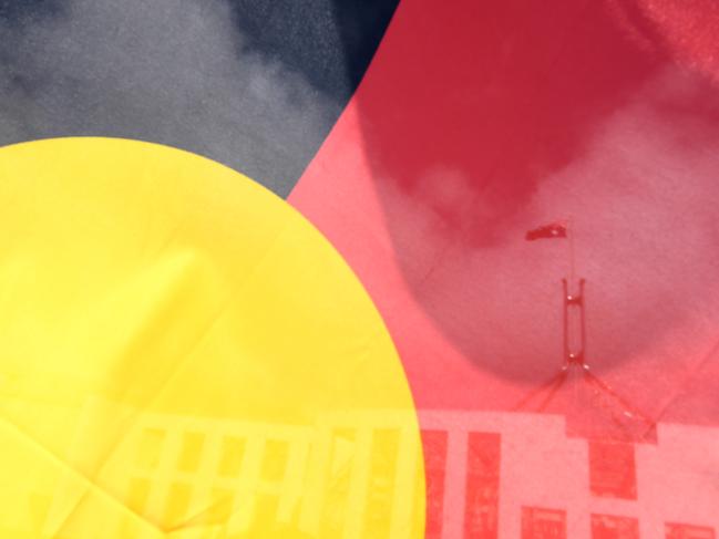 Australian Parliament House is seen through an Aboriginal flag in Canberra, Tuesday, September 5, 2017. (AAP Image/Lukas Coch) NO ARCHIVING