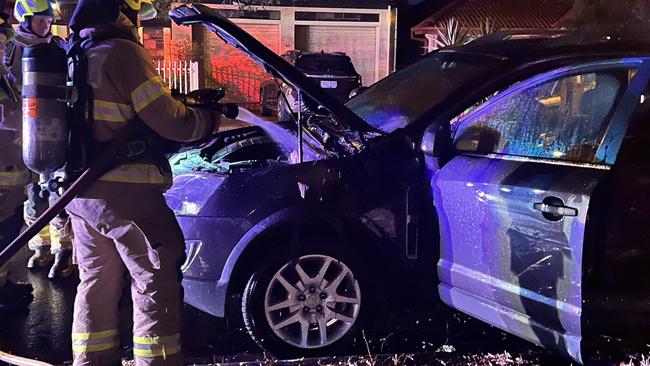 Firefighters attend to Gretta's car shortly after the attack.