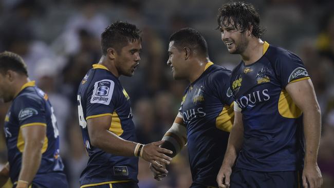 Sam Carter of the Brumbies, right, celebrates with teammates after scoring a try against the Hurricanes in round one.