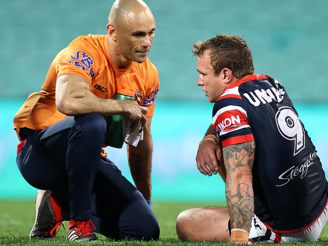 SYDNEY, AUSTRALIA - AUGUST 28:  Jake Friend of the Roosters is attended to by a trainer after a tackle during the round 16 NRL match between the Sydney Roosters and the Brisbane Broncos at the Sydney Cricket Ground on August 28, 2020 in Sydney, Australia. (Photo by Cameron Spencer/Getty Images)