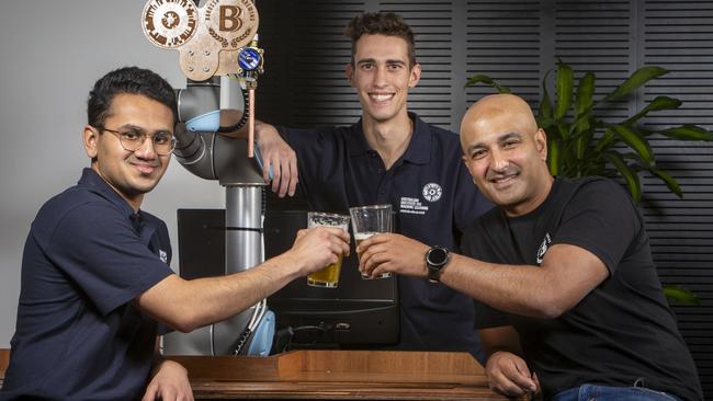 Australian Institute for Machine Learning interns from Adelaide University Jash Vira and Christopher Fusco taste test the beer with Barossa Valley Brewing founder Denham D’Silva. Picture: Emma Brasier