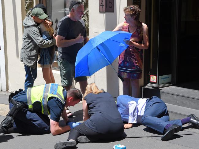 Bystanders comfort each other after pedestrians were mowed down. Picture: Tony Gough