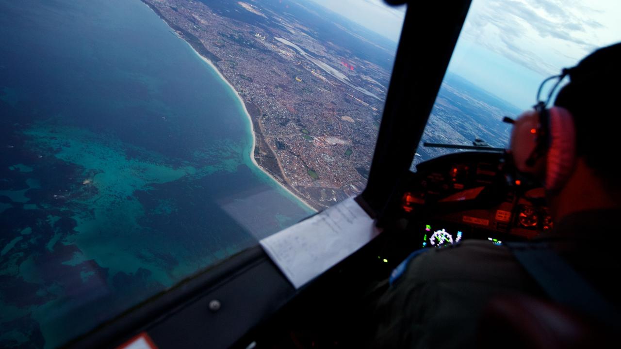 Crew on-board an RAAF AP-3C Orion who just completed an 11 hour search mission for MH370, before landing at RAAF Pearce air base on March 24, 2014 in Perth. Picture: Richard Wainwright/Getty Images