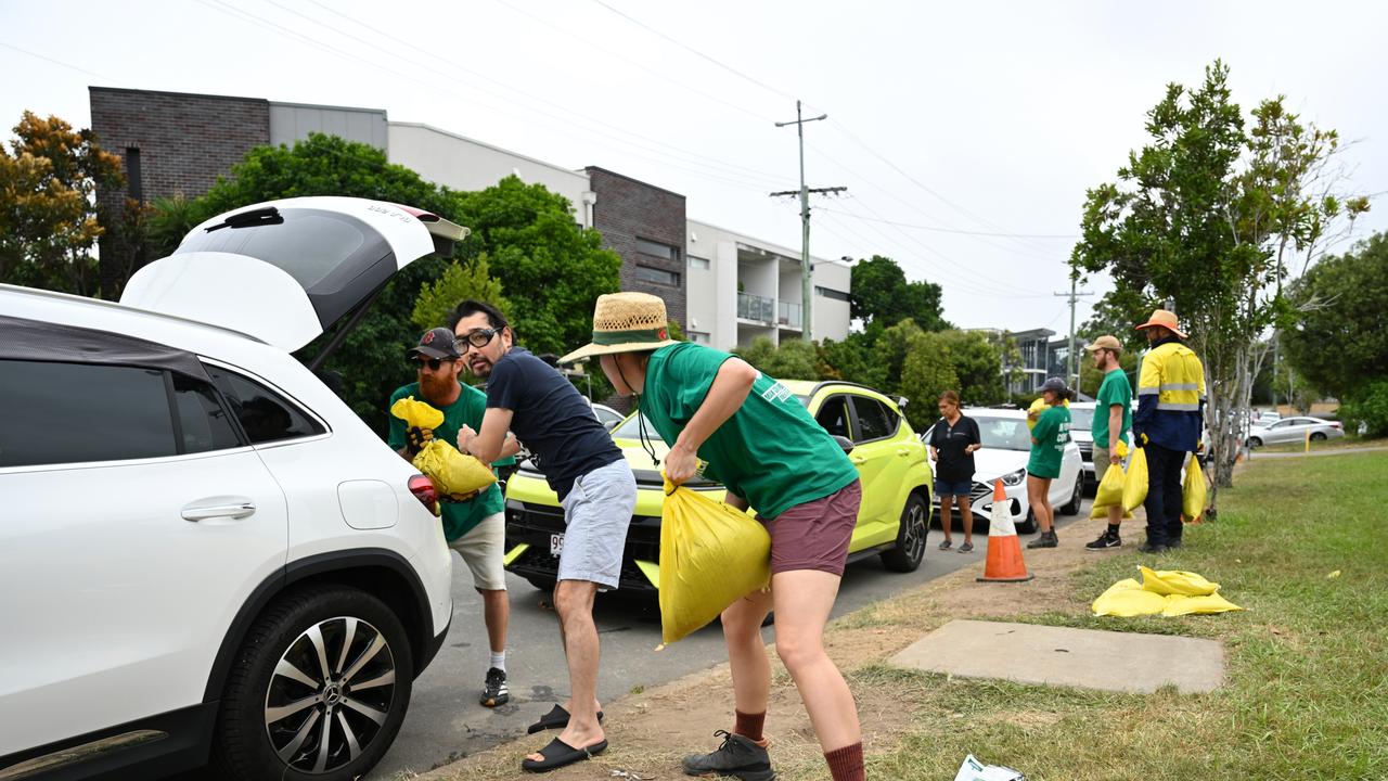 Volunteers help load sandbags into residents' cars at a Morningside sandbag depot. (Photo by Albert Perez/Getty Images)