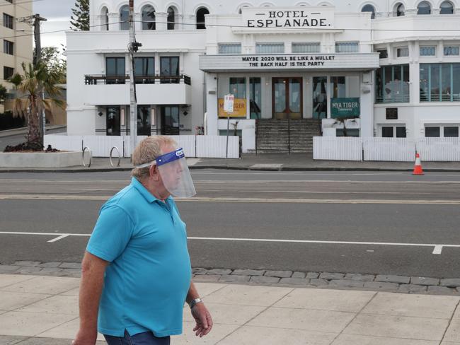 A man walks past the closed Esplanade hotel in St Kilda during COVID-19 stage four lockdown in Melbourne. Picture: NCA NewsWire/ David Crosling