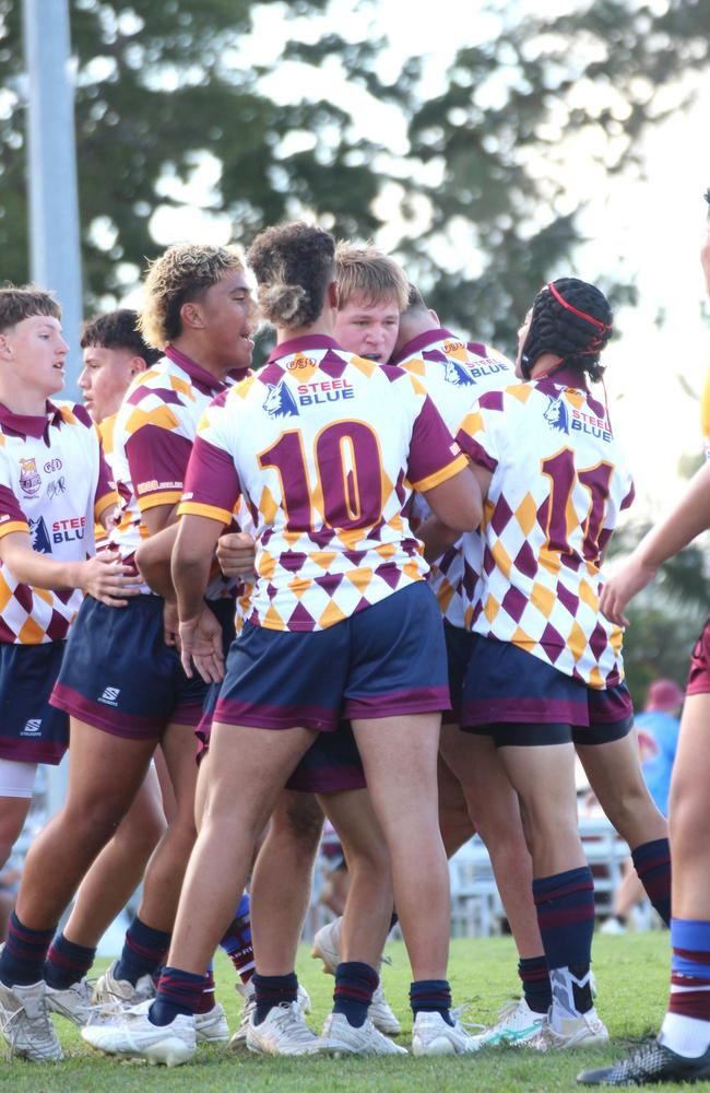 Jack Neuendorf is swarmed by teammates after scoring the first try.