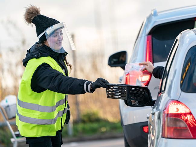 A Covid-19 test is handed out of a car at a railway station in Malmo, Sweden. Picture: AFP