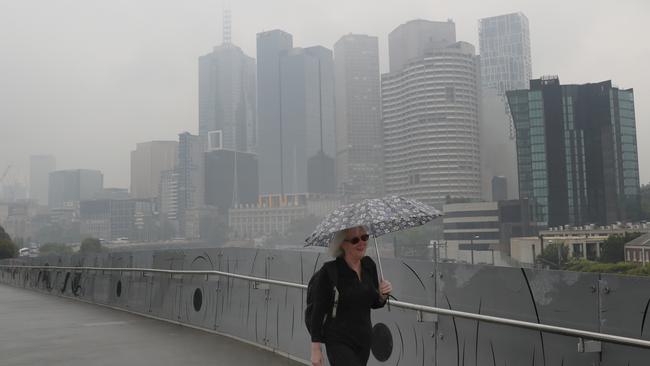 Smoke haze and light rain hang over the Melbourne CBD. Picture: David Crosling